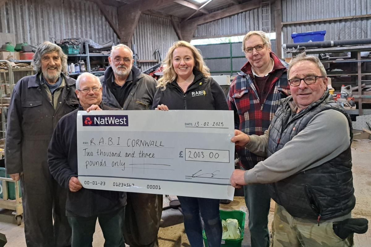 5 members of TREC presenting a cheque of £2,003 to RABI's South West Regional Manager Zoe Gascoyne