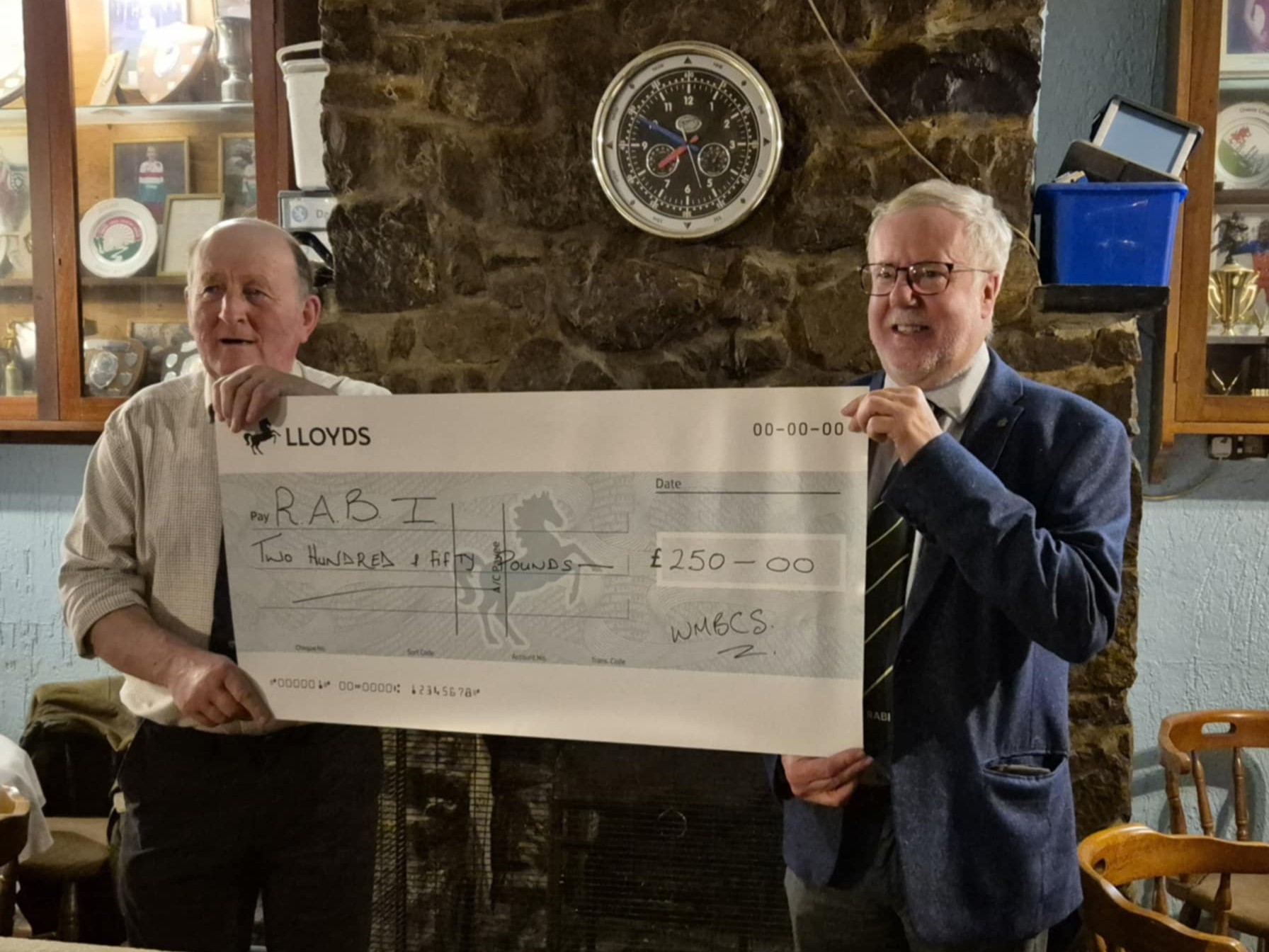 RABI Trustee Delme Harris accepting a cheque of £250 from the Welsh Black Cattle Society's Vice Chairman Robert Morgan