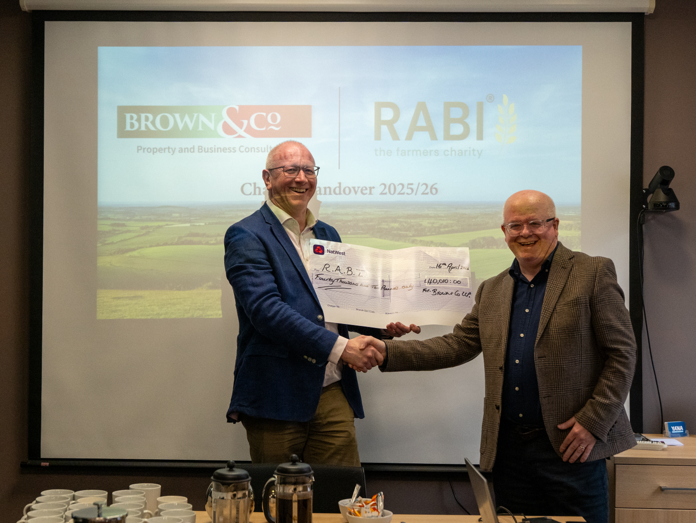 Photo of Andrew Fundell, Partner at Brown & Co, handing over a cheque to Paul Pirie, RABI's Head of Fundraising