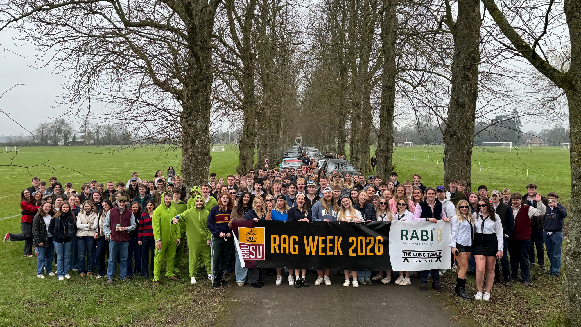 Royal Agricultural University students holding a banner reading 'RAG WEEK 2026'.