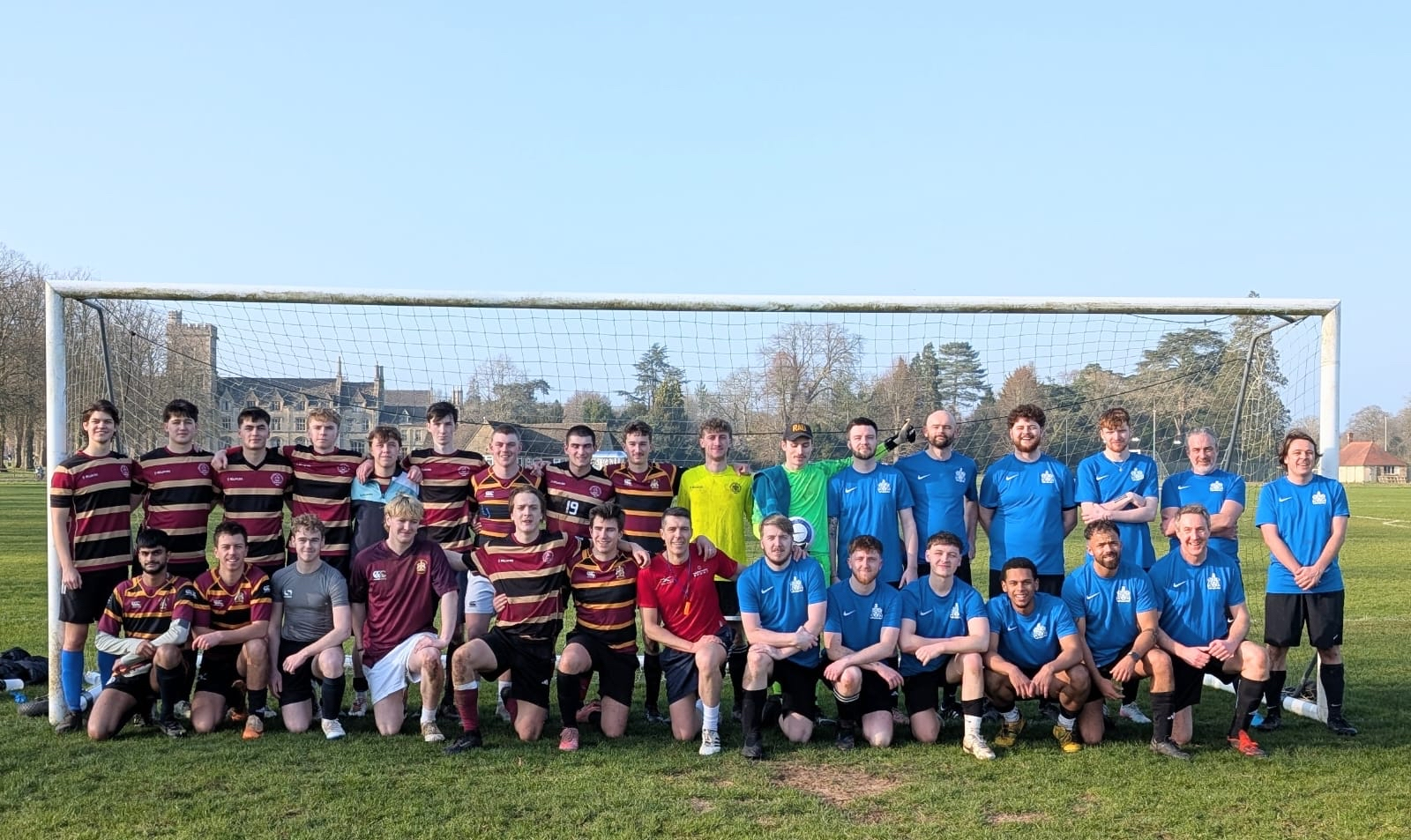 Royal Agricultural Students at charity football match stood in front of a goal