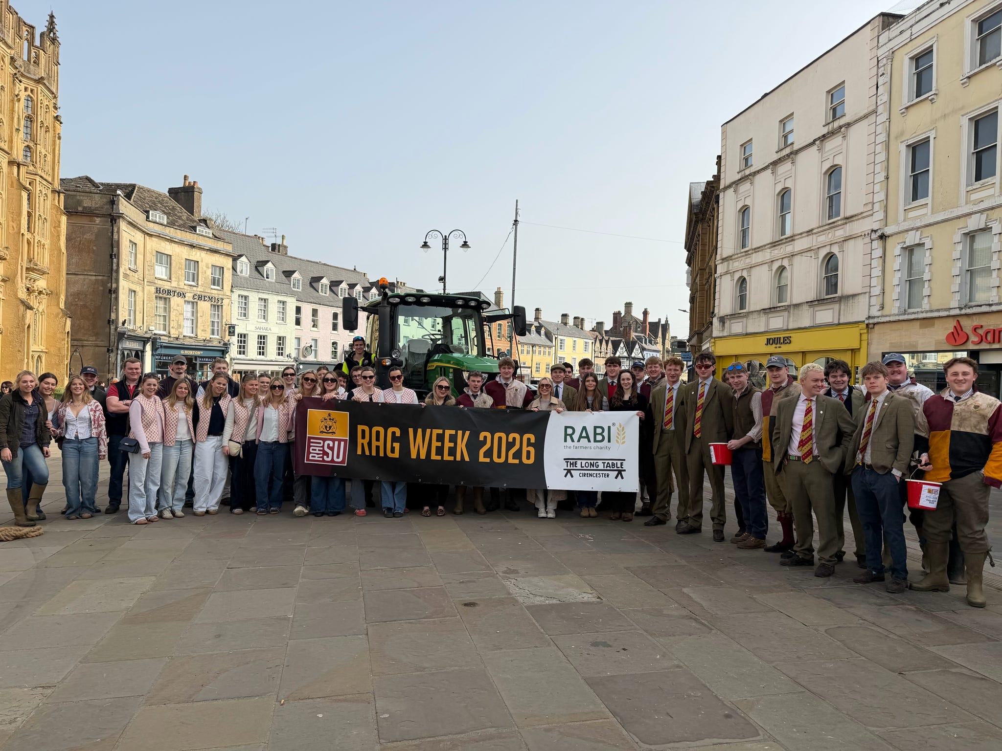 Royal Agricultural University students holding a banner reading 'RAG WEEK 2026'.