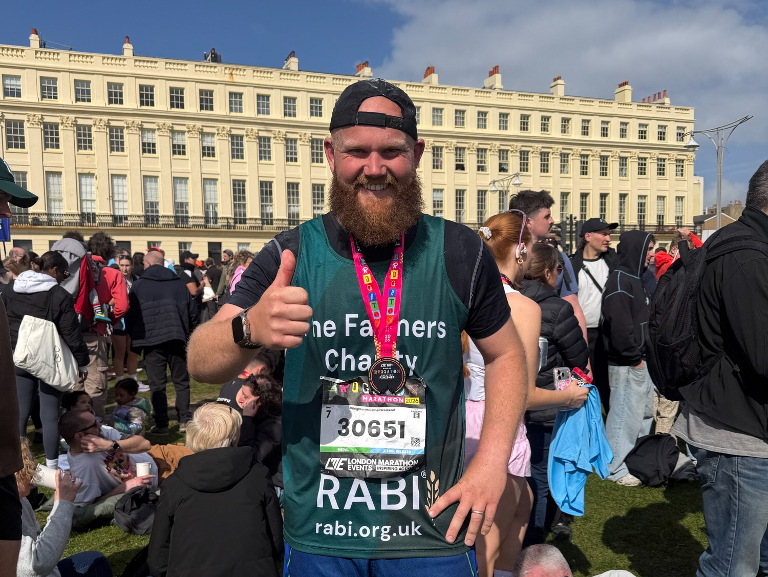 Simon Foot wearing an RABI running vest and a medal