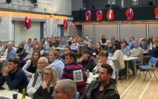 A group of participants sat watching the stage at Diss Young Farmers' Club Race Night