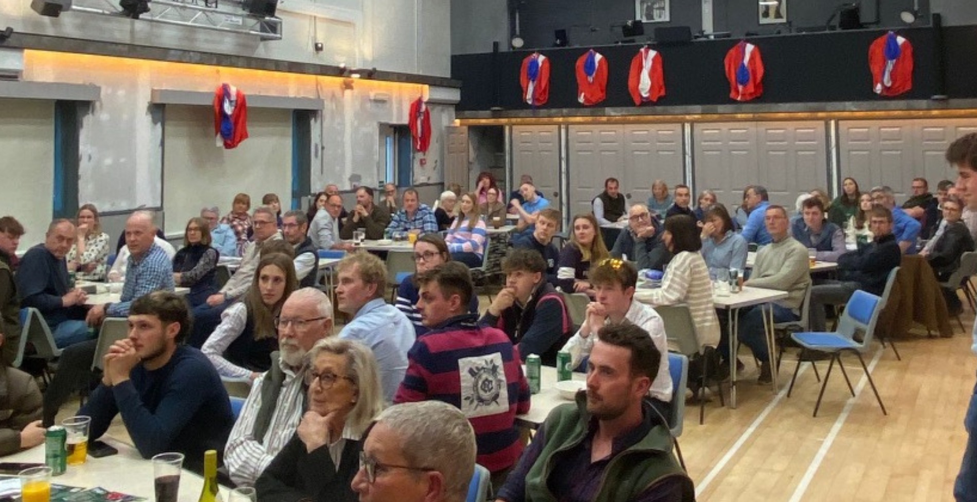 A group of participants sat watching the stage at Diss Young Farmers' Club Race Night